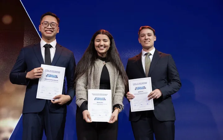 Faiz with the other Global Essay Competition winners holding their certificates at St. Gallen